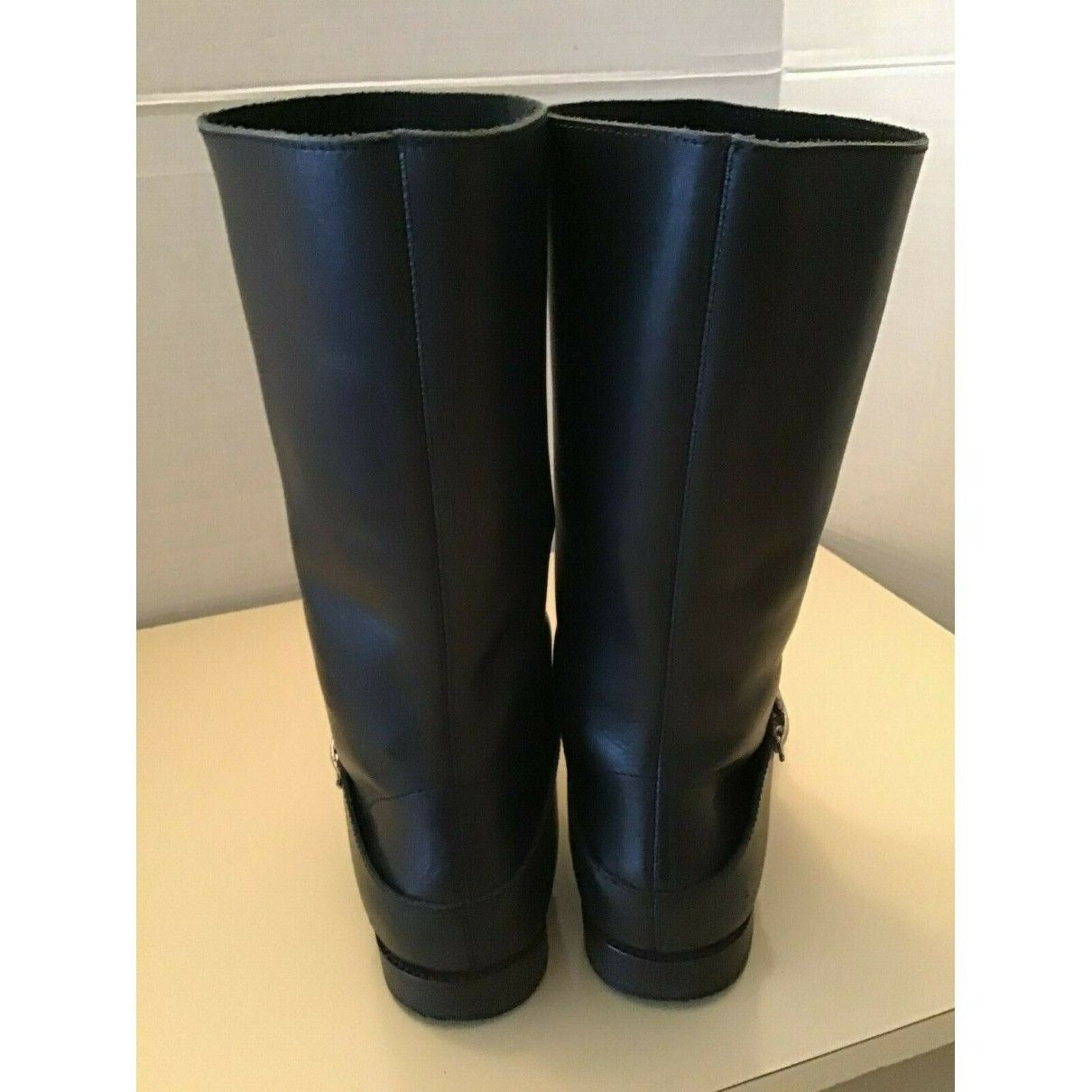 A pair of See by Chloe, size 7, black leather moto style boots with pull on closure, rounded toes, 1" block heels, and chrome buckles