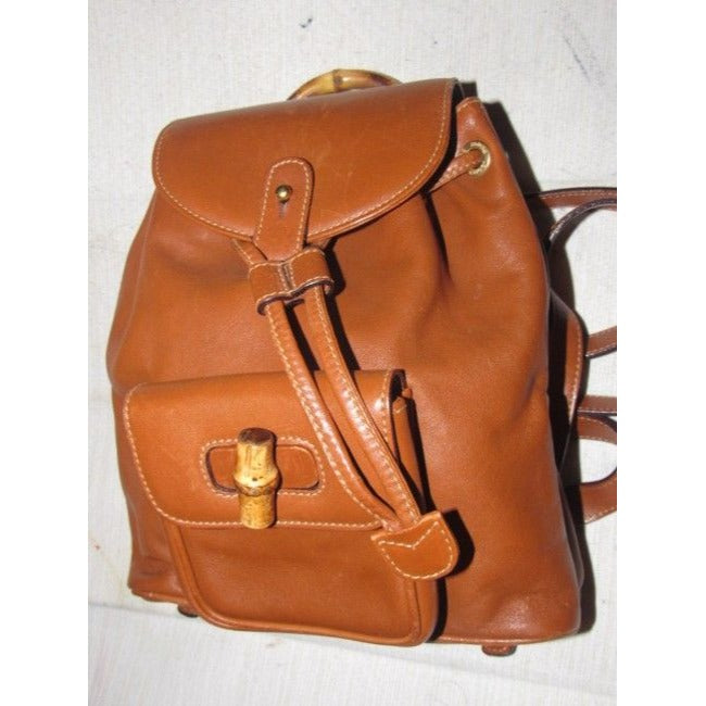 Gucci caramel brown colored leather, two strap, petite, drawstring top, multi-pocket, messenger bag/backpackk