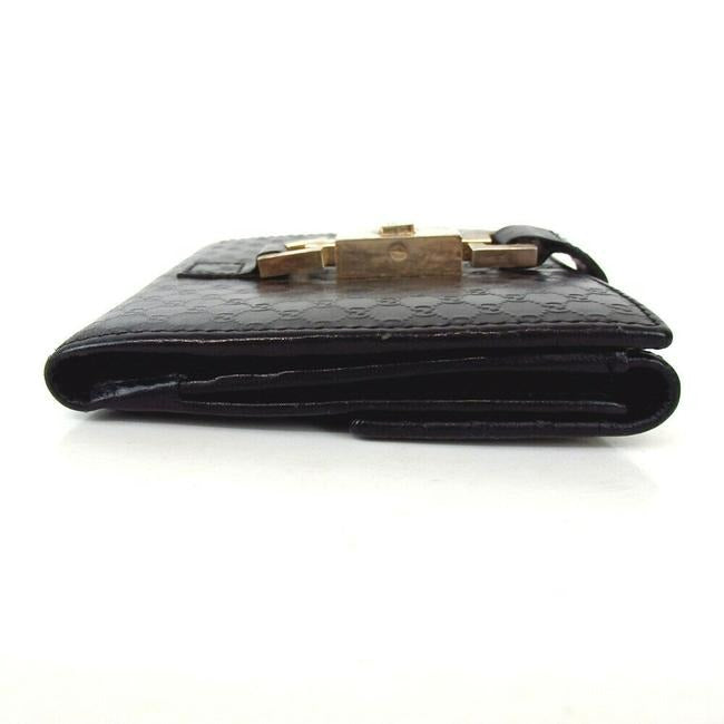 OUR MOST LIKED WALLET! Gucci, Jackie style, black micro Guccissima print leather, bi-fold wallet with chrome, Jackie style, push button closure, chrome accents, and lots of slots for your cards!