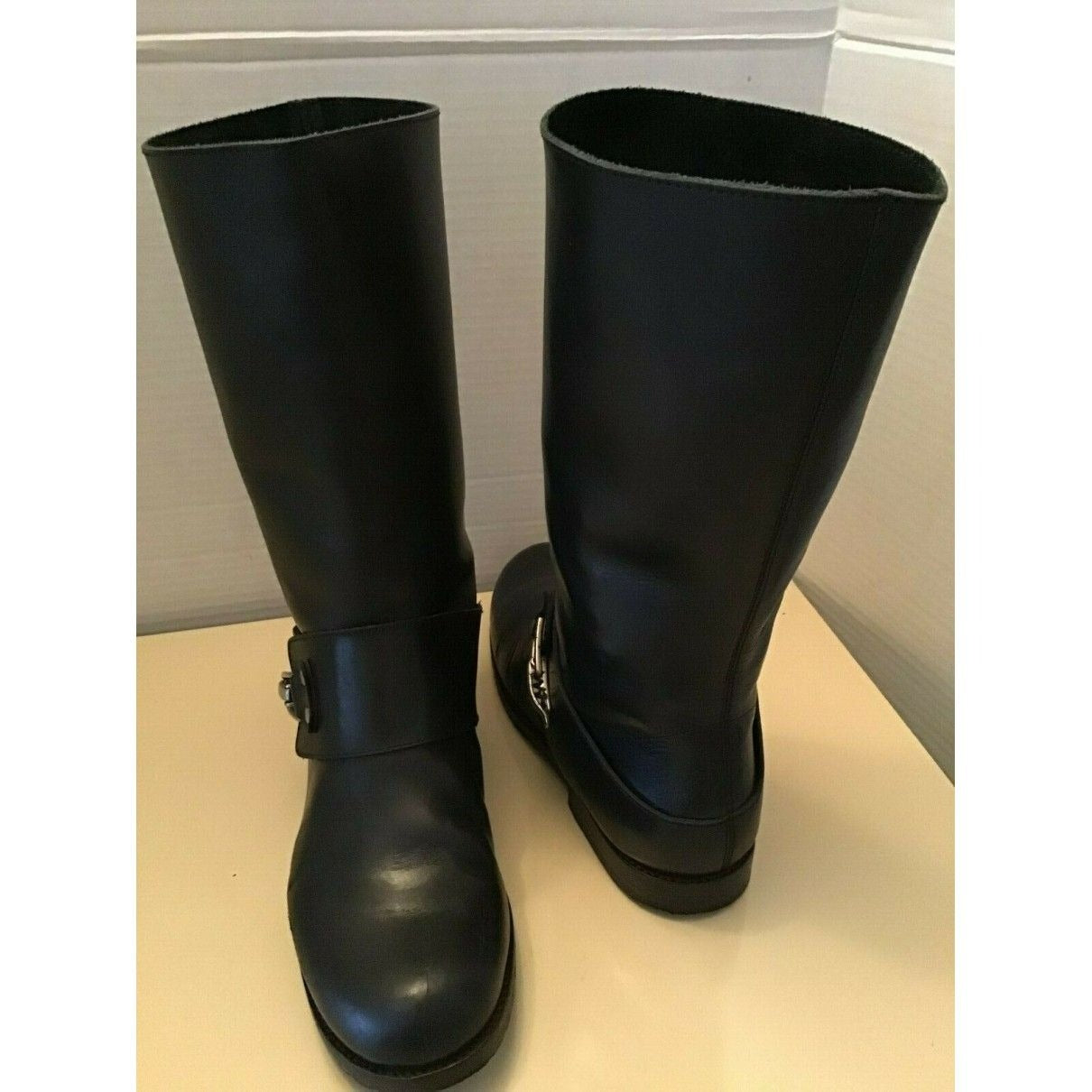 A pair of See by Chloe, size 7, black leather moto style boots with pull on closure, rounded toes, 1" block heels, and chrome buckles