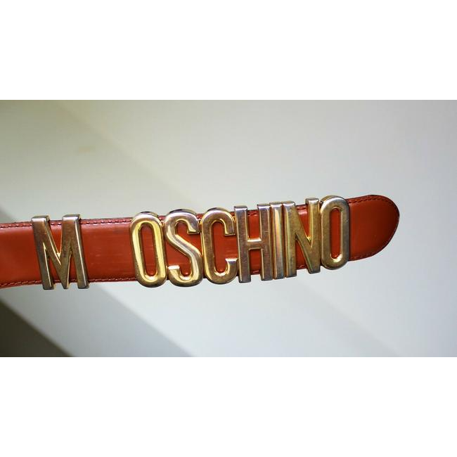 Moschino, Redwall, glossy brown leather belt with large, polished gold letters that spell out 'MOSCHINO' and can slide to act as a double snap buckle