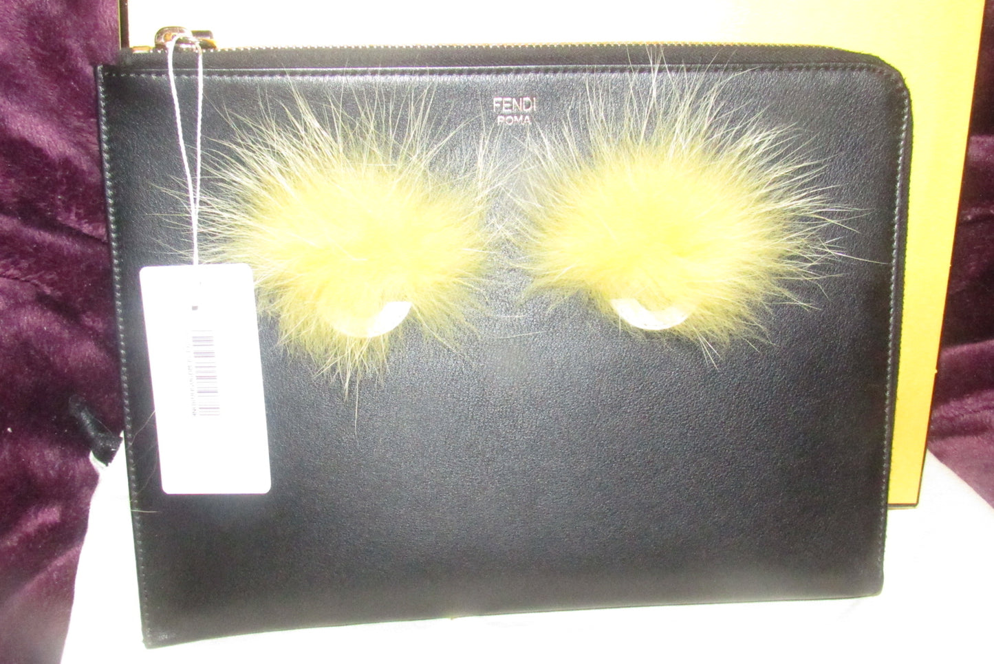 Fendi NIB w tags, black leather 'Monster' clutch w yellow fur lashes and zip around closure