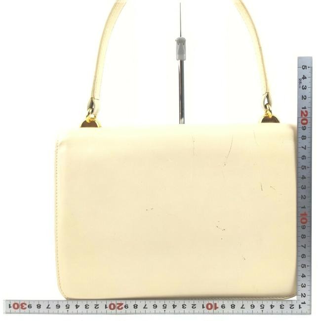 Vintage, Gucci, cream leather, 1973 top handle style purse with gold tone accents!