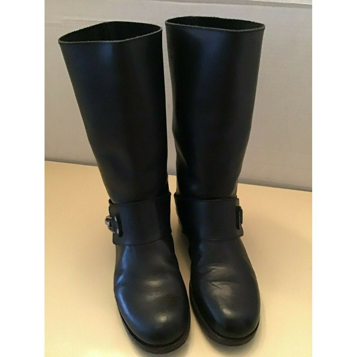 A pair of See by Chloe, size 7, black leather moto style boots with pull on closure, rounded toes, 1" block heels, and chrome buckles