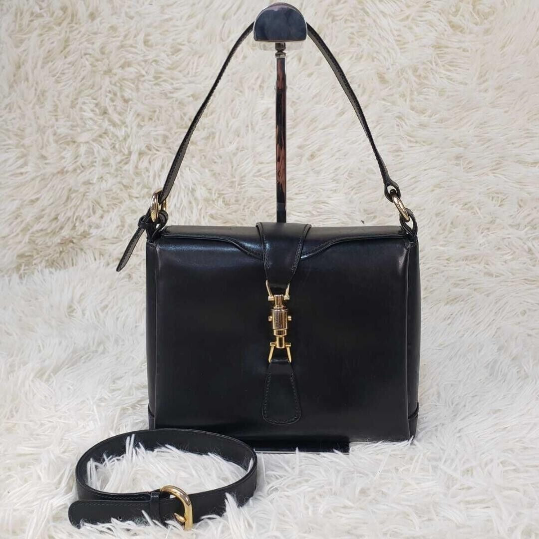 RARE, Gucci, Jackie mod, navy blue leather, boxy, cross body or shoulder purse with bold gold tone accents, a flap strap closure at the cent