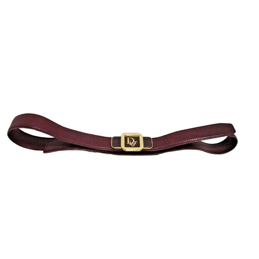 Vintage Christian Dior rich burgundy leather belt with an enamel and goldtone logo buckle accent