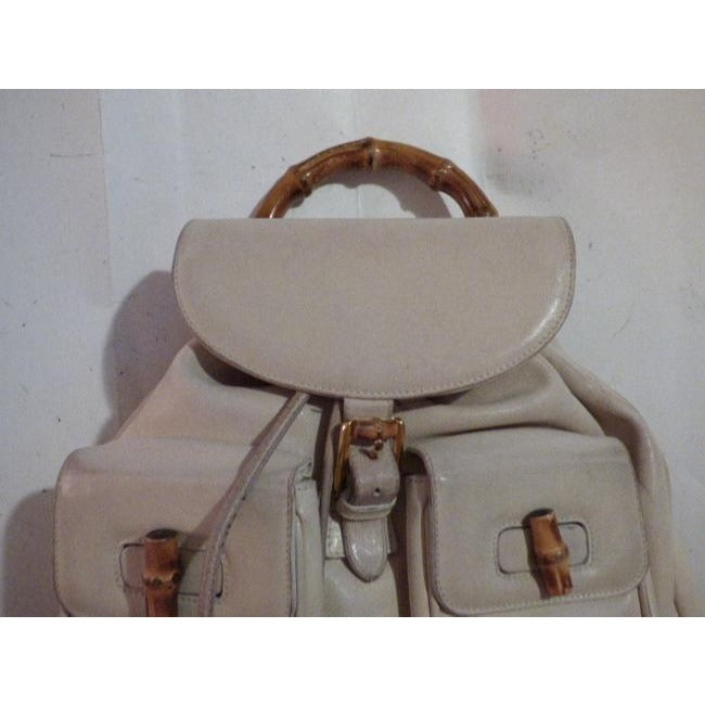 Gucci, white leather, larger size, two strap and bamboo handle, drawstring top, multi-pocket, messenger bag/backpack